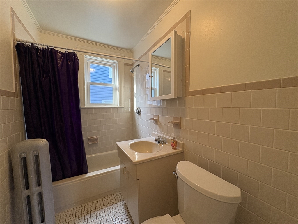 155-157 Hillside Street, Unit 1 Boston, MA 02120 - Photo 13 of 18 a bathroom with a toilet a sink and shower