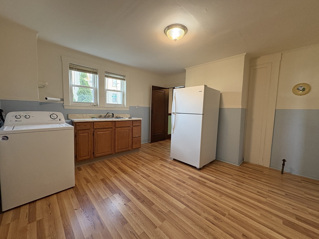 155-157 Hillside Street, Unit 1 Boston, MA 02120 - Photo 16 of 18 a kitchen with a refrigerator sink and cabinets