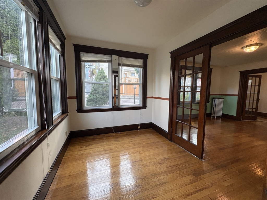 155-157 Hillside Street, Unit 1 Boston, MA 02120 - Photo 8 of 18 a view of an empty room with large windows