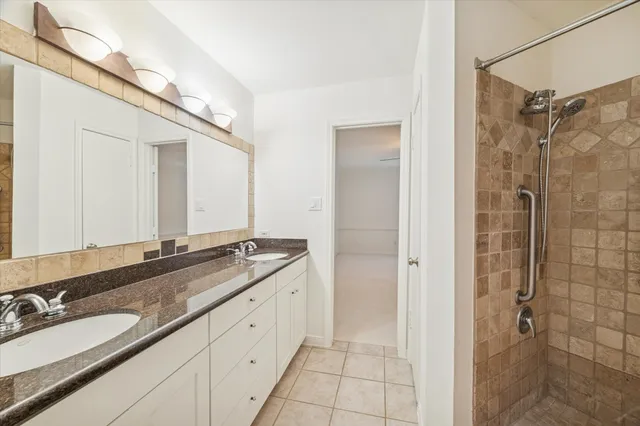 a bathroom with a granite countertop sink mirror and double