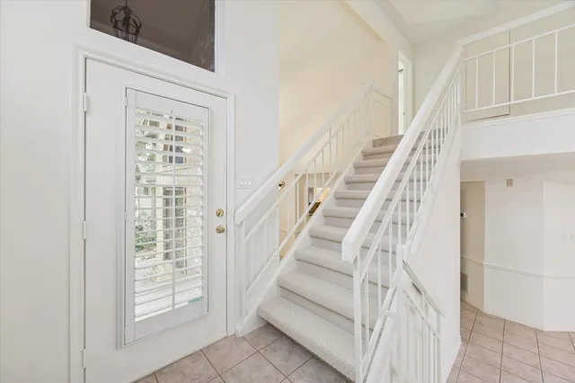 a view of staircase with white walls and windows