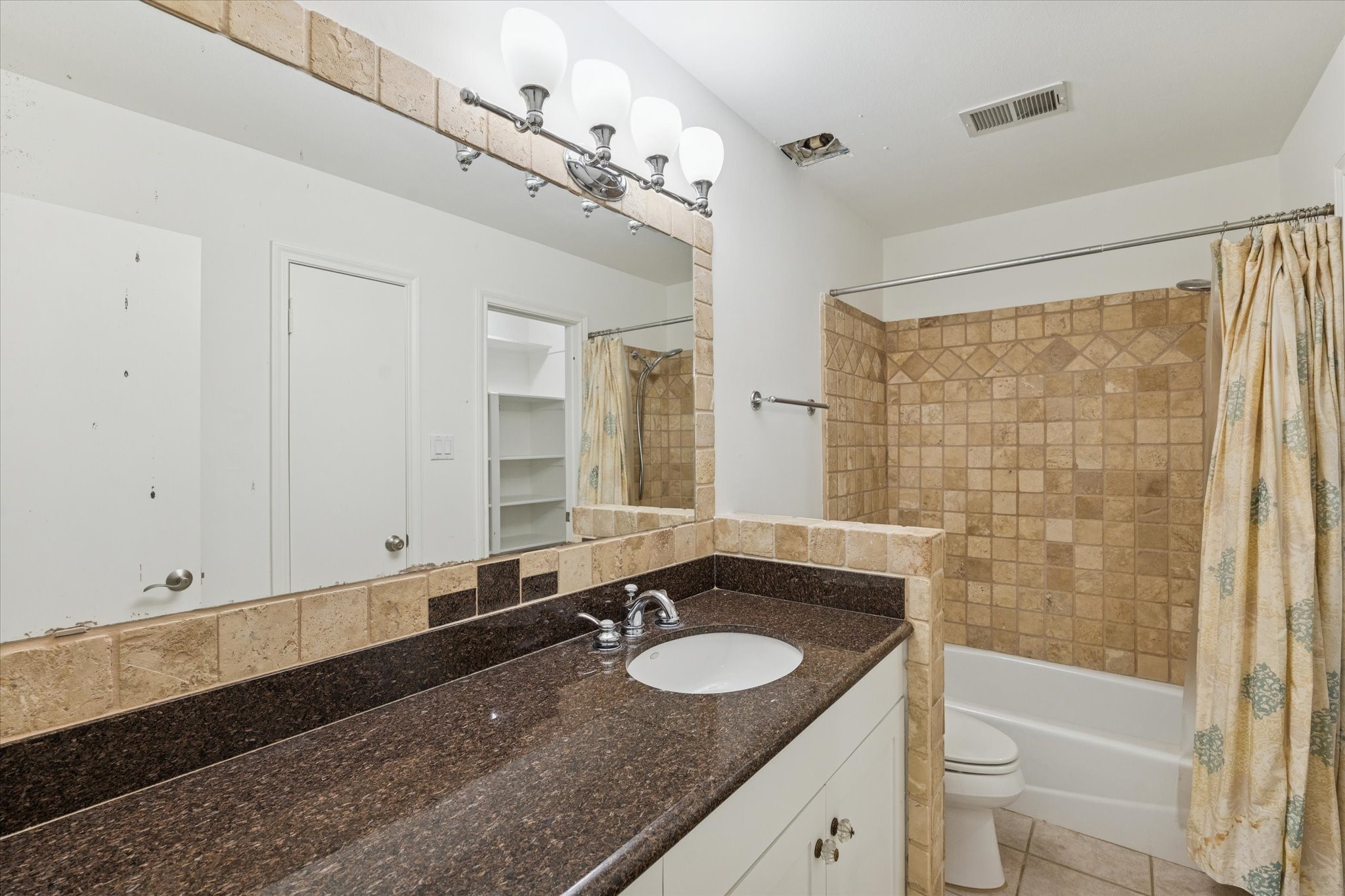 12 Lakeridge Drive Spring, TX 77381 - Photo 19 of 24 a bathroom with a granite countertop sink a toilet a mirror and shower