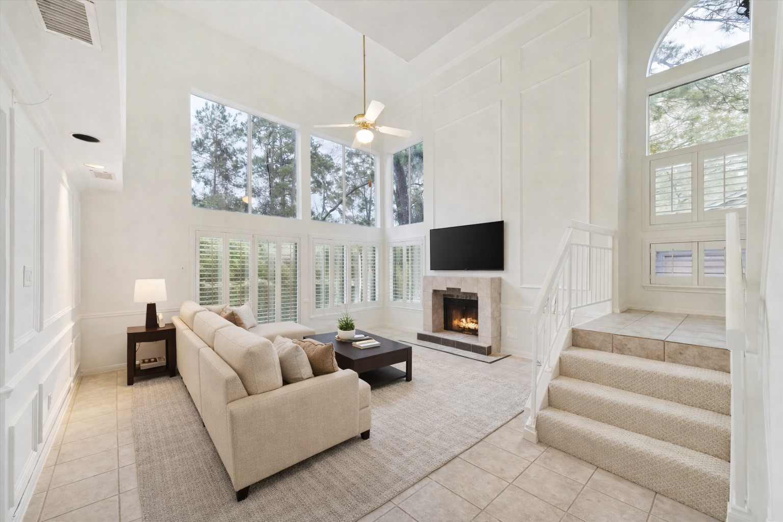 12 Lakeridge Drive Spring, TX 77381 - Photo 2 of 24 a living room with furniture a fireplace and a flat screen tv