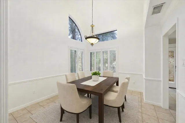 a view of a dining room with furniture and a floor to ceiling window