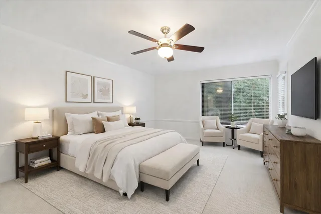 a bedroom with a bed and a large window