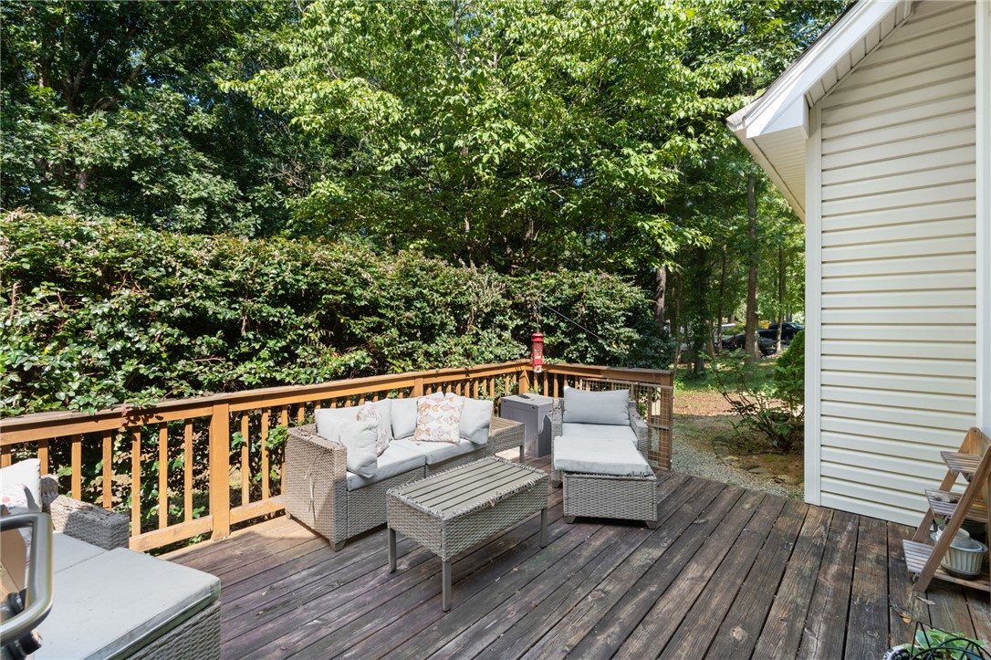 108 Winterbrook Circle Seneca, SC 29678 - Photo 32 of 40 A spacious wooden deck provides ample outdoor living space, surrounded by verdant trees and lush landscaping.