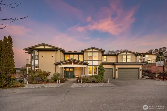 a front view of a house with a yard and balcony