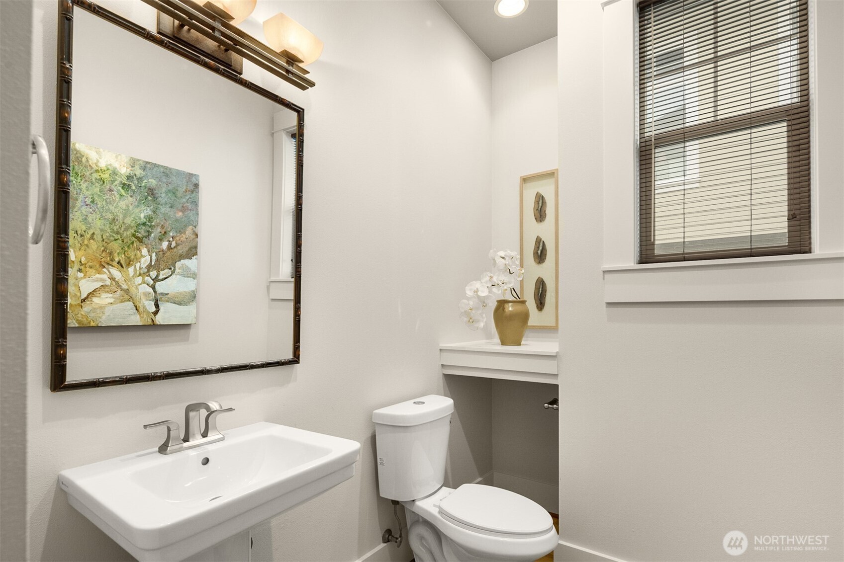 1500 South 5th Place Renton, WA 98057 - Photo 18 of 40 a bathroom with a toilet a sink and mirror