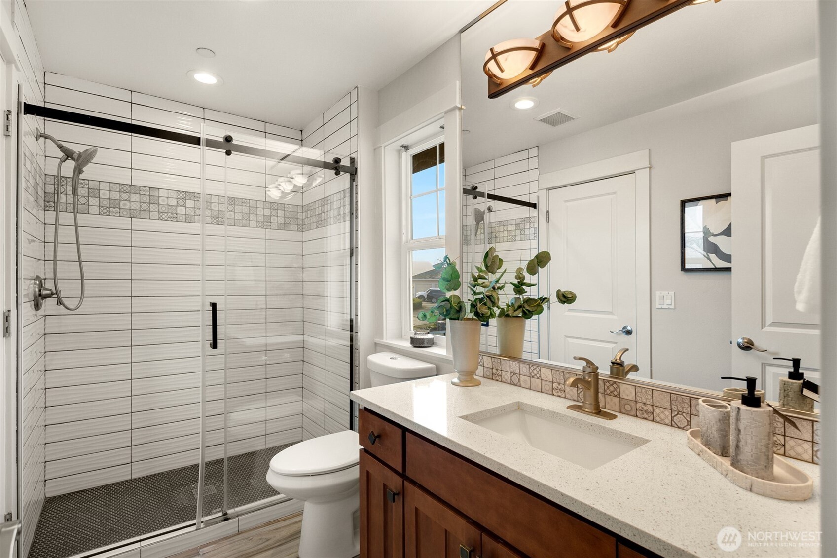 1500 South 5th Place Renton, WA 98057 - Photo 23 of 40 a bathroom with a granite countertop sink toilet and shower