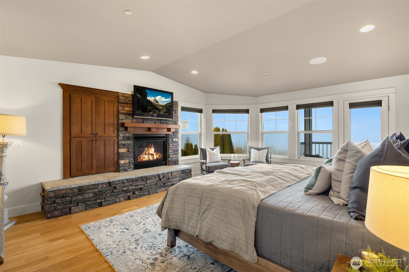 1500 South 5th Place Renton, WA 98057 - Photo 28 of 40 a spacious bedroom with a bed and a flat screen tv