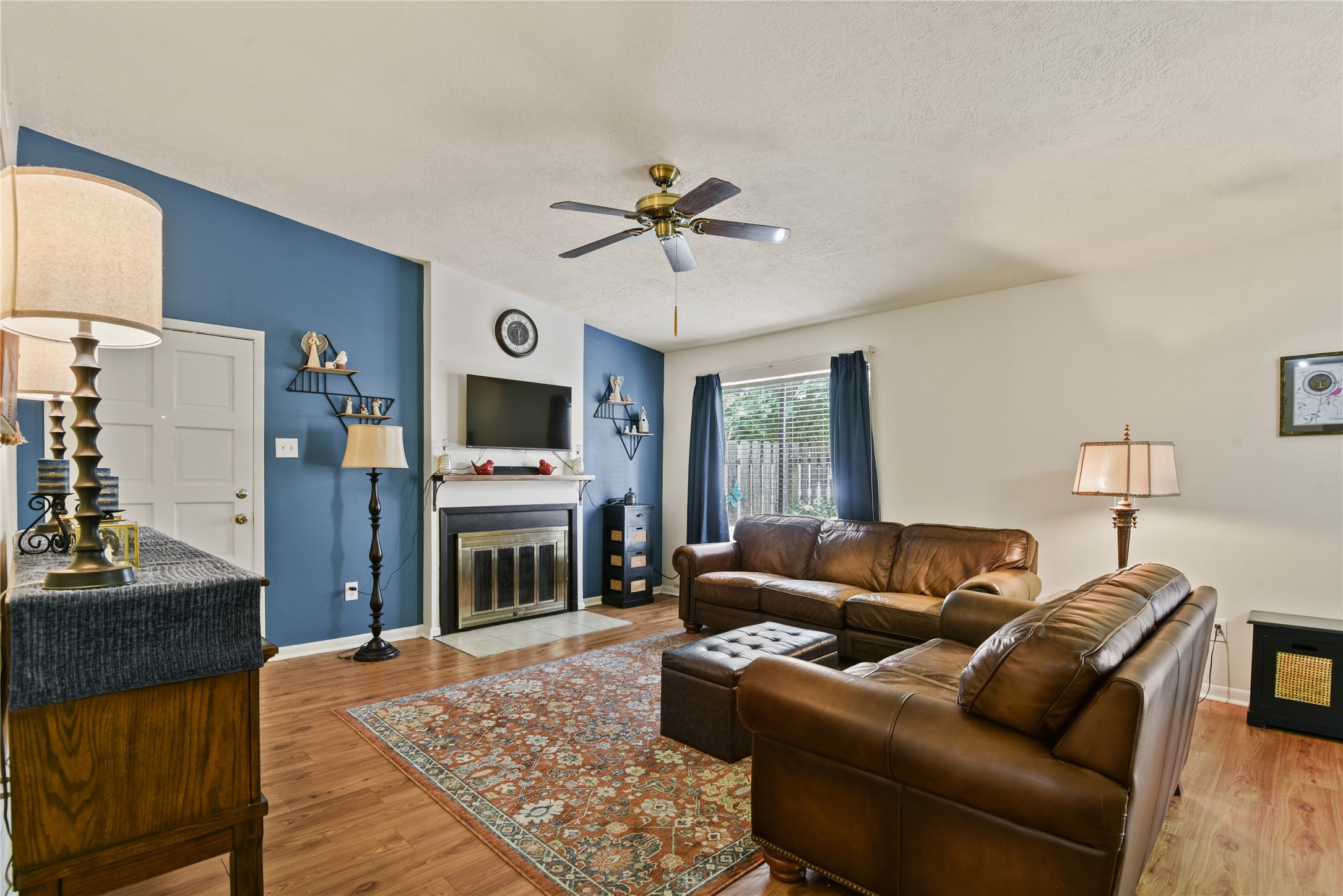 546 Georgetown Street, Unit 4 Beaumont, TX 77707 - Photo 3 of 14 a living room with furniture a flat screen tv and a fireplace