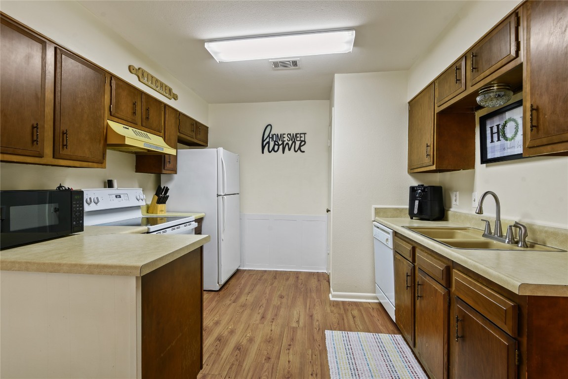 546 Georgetown Street, Unit 4 Beaumont, TX 77707 - Photo 8 of 14 a kitchen with stainless steel appliances granite countertop a sink stove and refrigerator