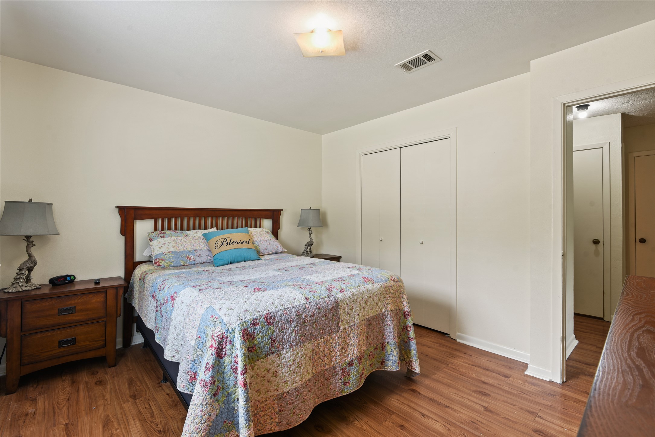 546 Georgetown Street, Unit 4 Beaumont, TX 77707 - Photo 10 of 14 a bedroom with a bed and wooden floor