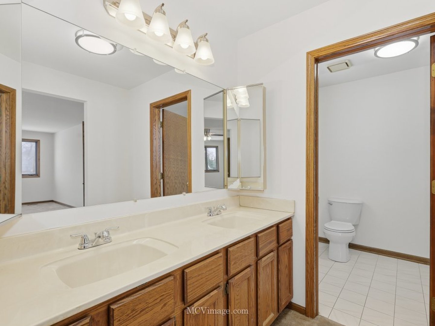 729 Eighth Avenue Addison, IL 60101 - Photo 12 of 21 a bathroom with a sink a toilet and a mirror