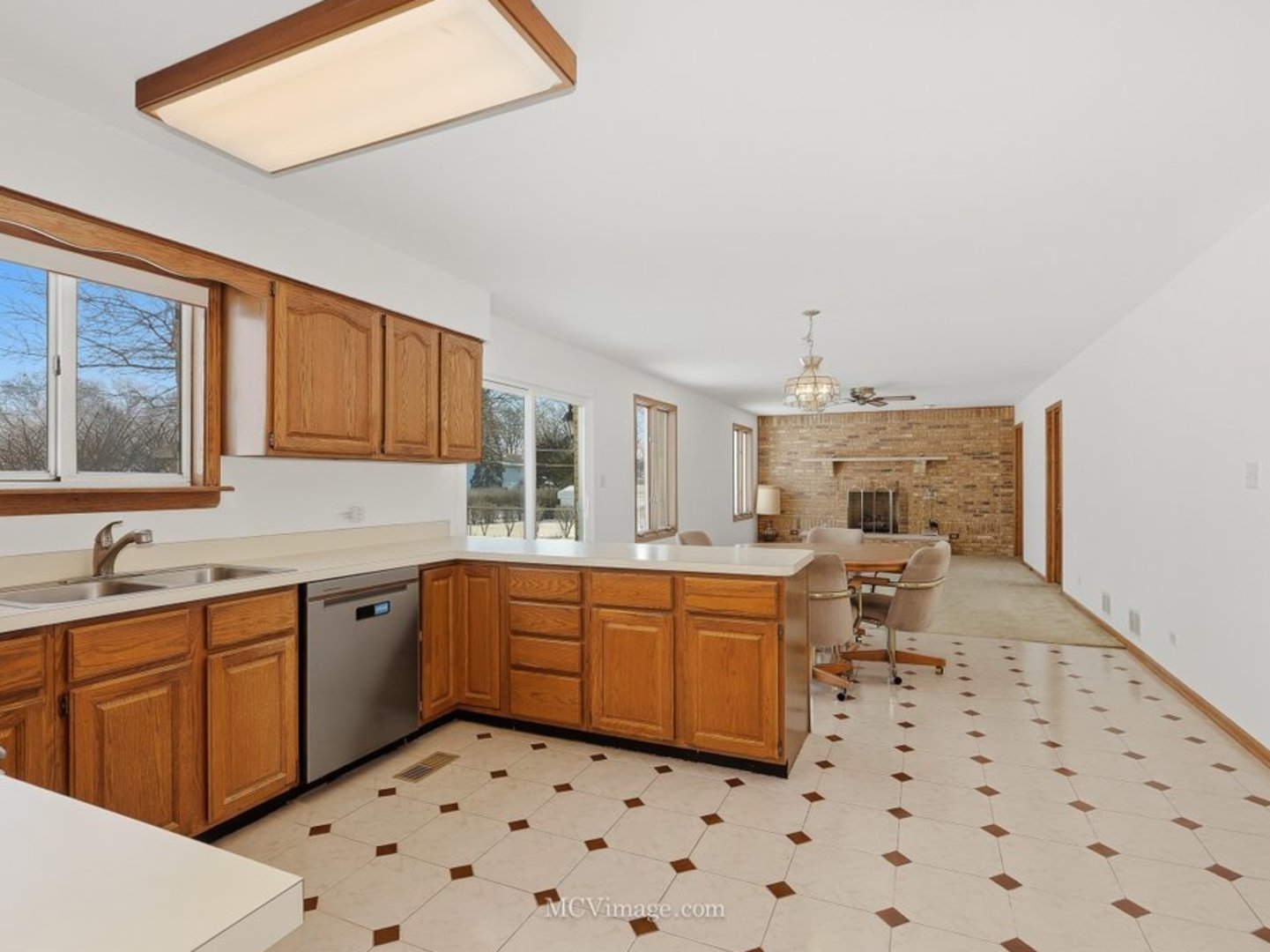 729 Eighth Avenue Addison, IL 60101 - Photo 6 of 21 a kitchen with a sink a stove a dining table and chairs