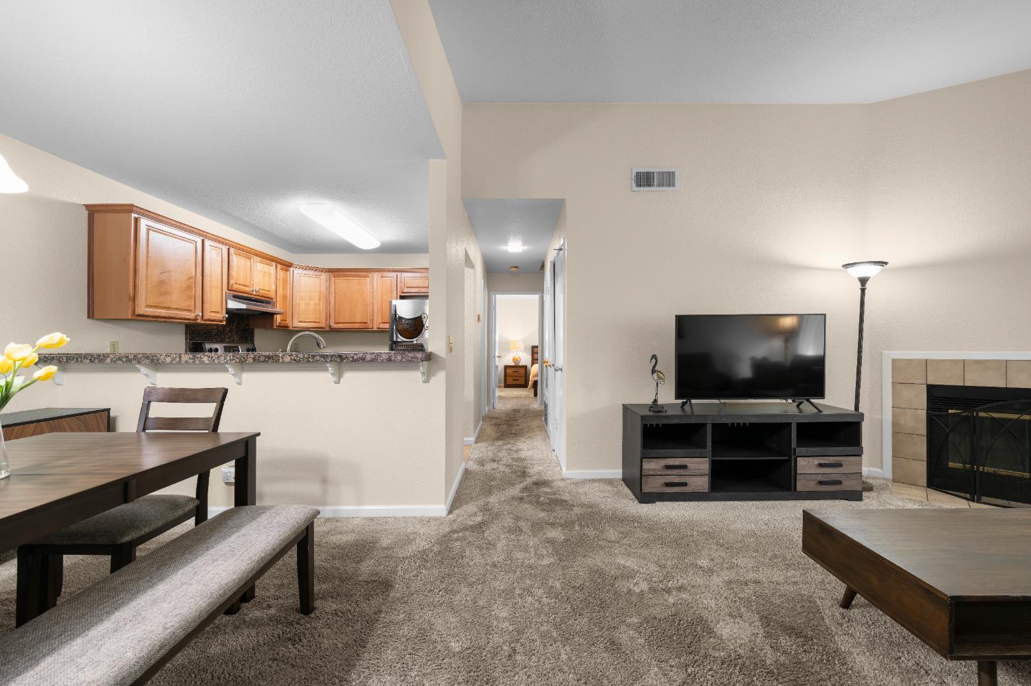 11150 Trinity River Drive, Unit 42 Rancho Cordova, CA 95670 - Photo 11 of 32 a living room with furniture and a flat screen tv