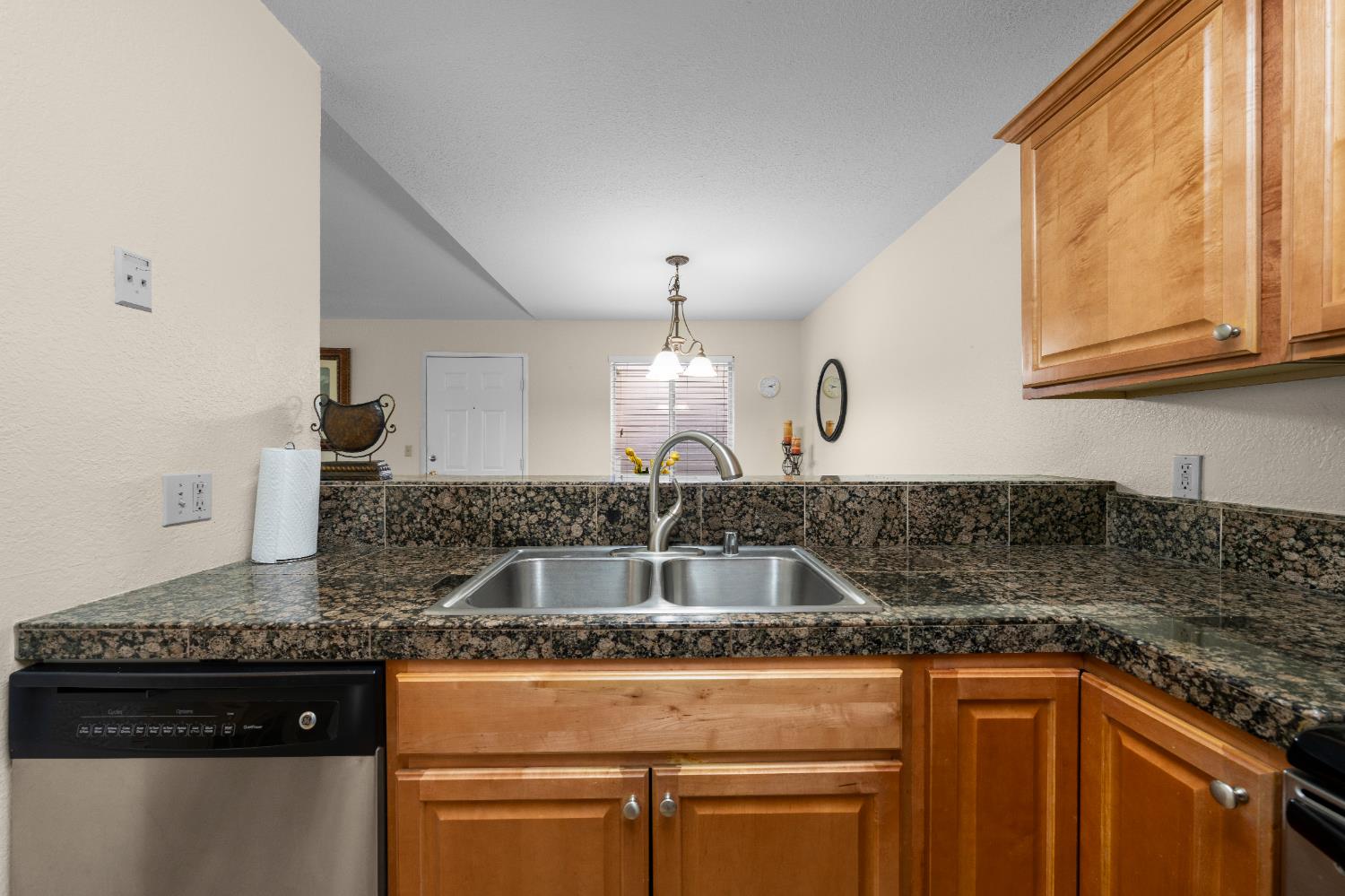 11150 Trinity River Drive, Unit 42 Rancho Cordova, CA 95670 - Photo 16 of 32 a kitchen with granite countertop a sink and a stove