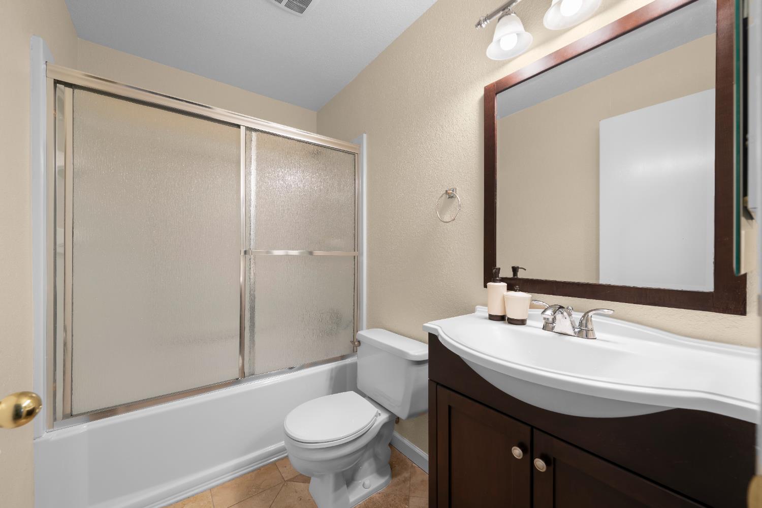 11150 Trinity River Drive, Unit 42 Rancho Cordova, CA 95670 - Photo 18 of 32 a bathroom with a sink and a mirror