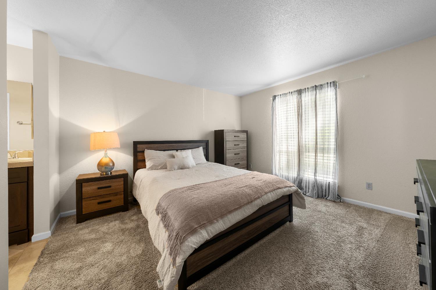 11150 Trinity River Drive, Unit 42 Rancho Cordova, CA 95670 - Photo 19 of 32 a bedroom with a bed and window