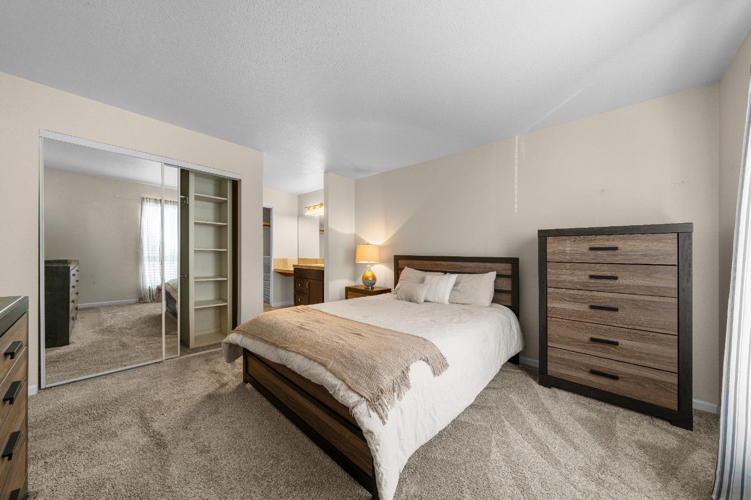 11150 Trinity River Drive, Unit 42 Rancho Cordova, CA 95670 - Photo 20 of 32 a bedroom with a bed and a mirror