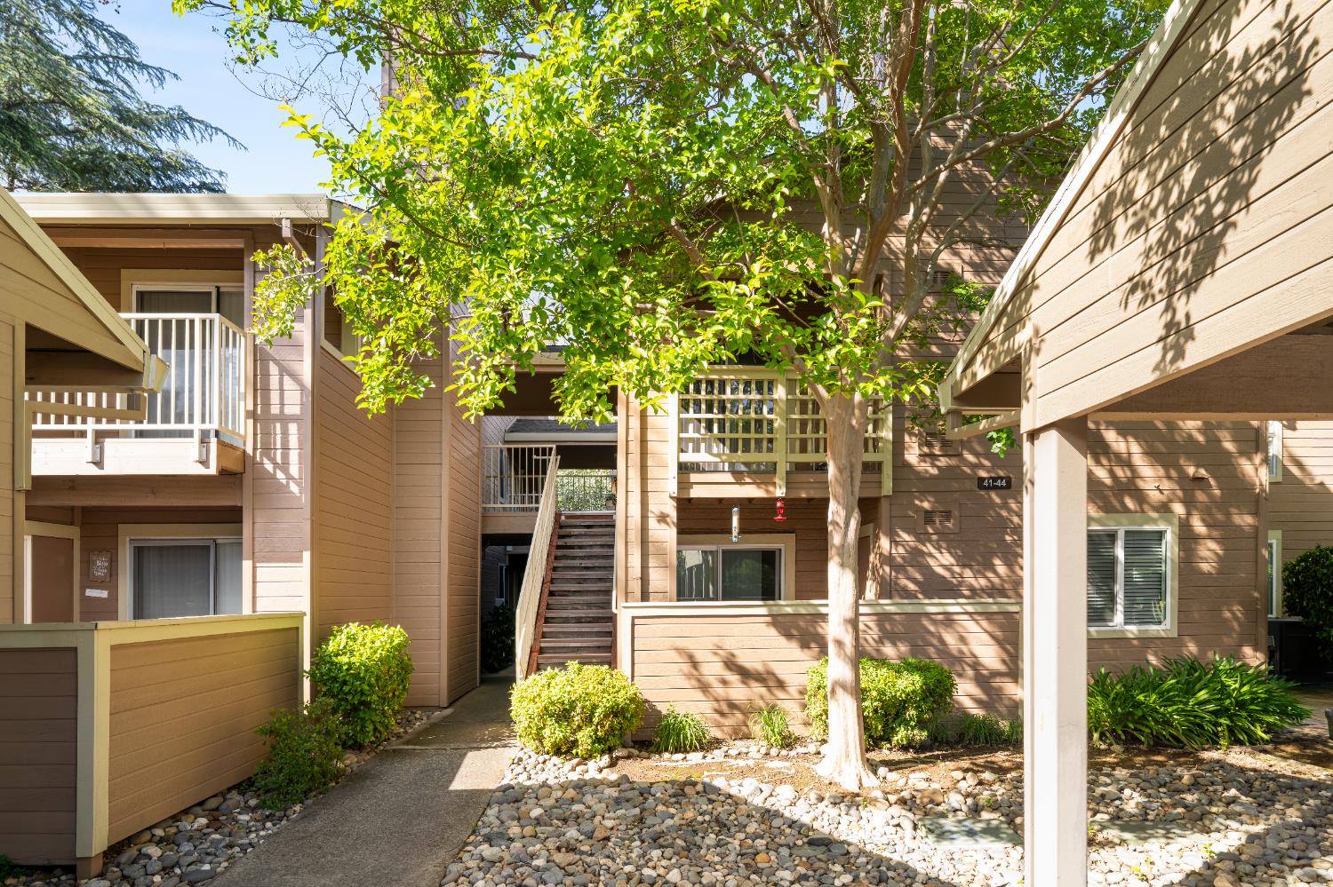 11150 Trinity River Drive, Unit 42 Rancho Cordova, CA 95670 - Photo 2 of 32 a view of a house with a tree in front of it