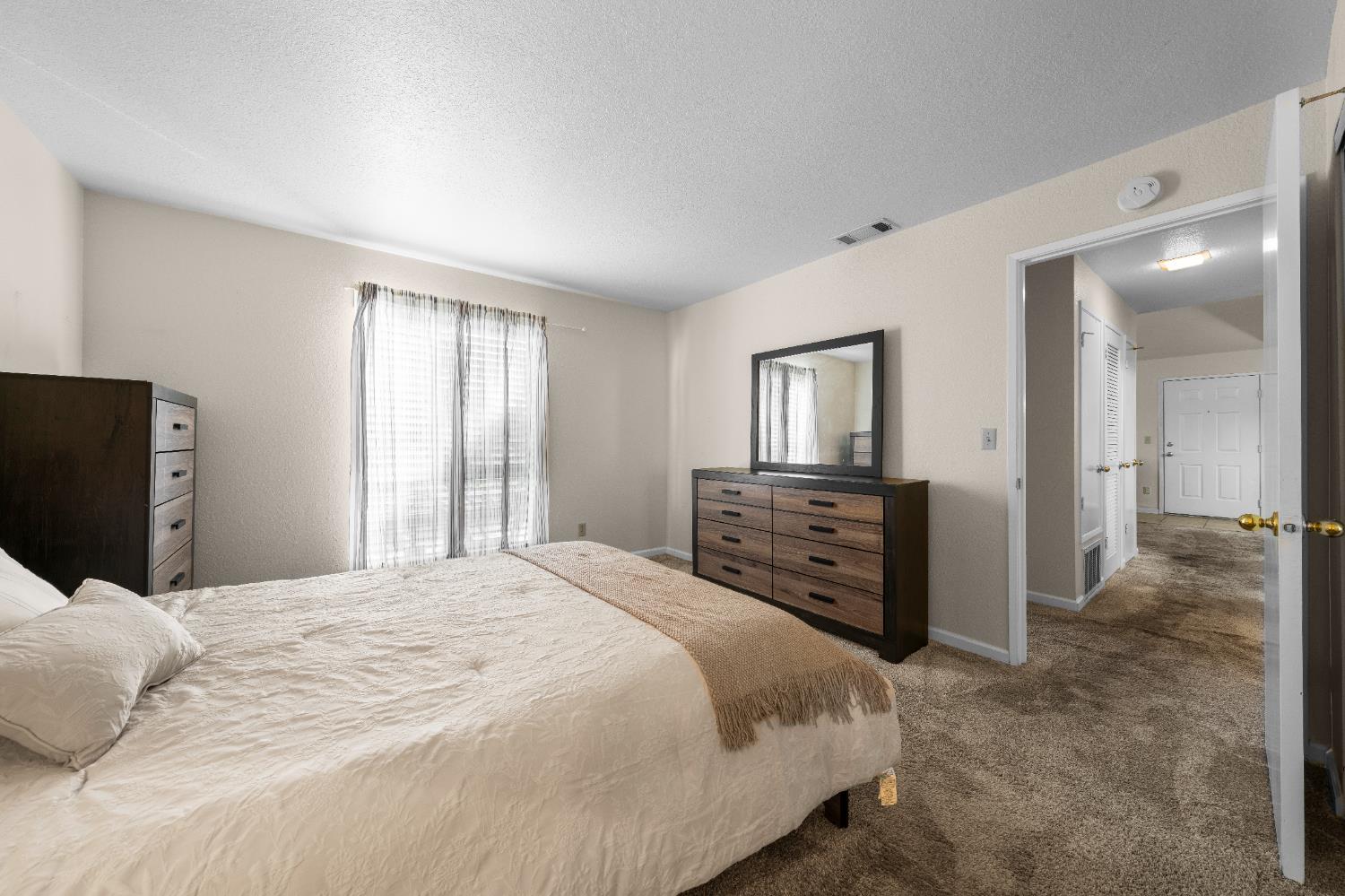 11150 Trinity River Drive, Unit 42 Rancho Cordova, CA 95670 - Photo 21 of 32 a bedroom with a bed and a television