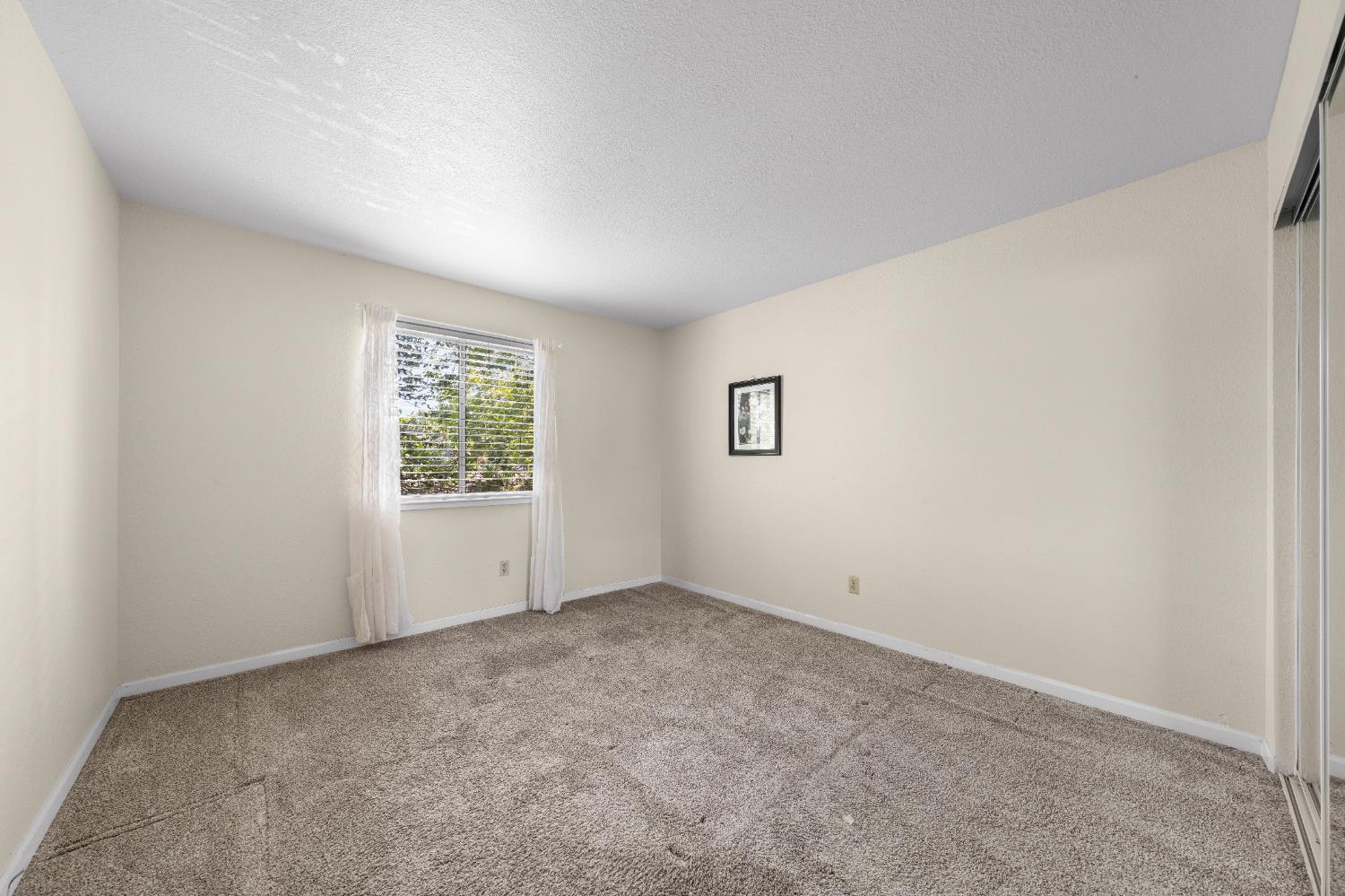 11150 Trinity River Drive, Unit 42 Rancho Cordova, CA 95670 - Photo 24 of 32 an empty room with windows