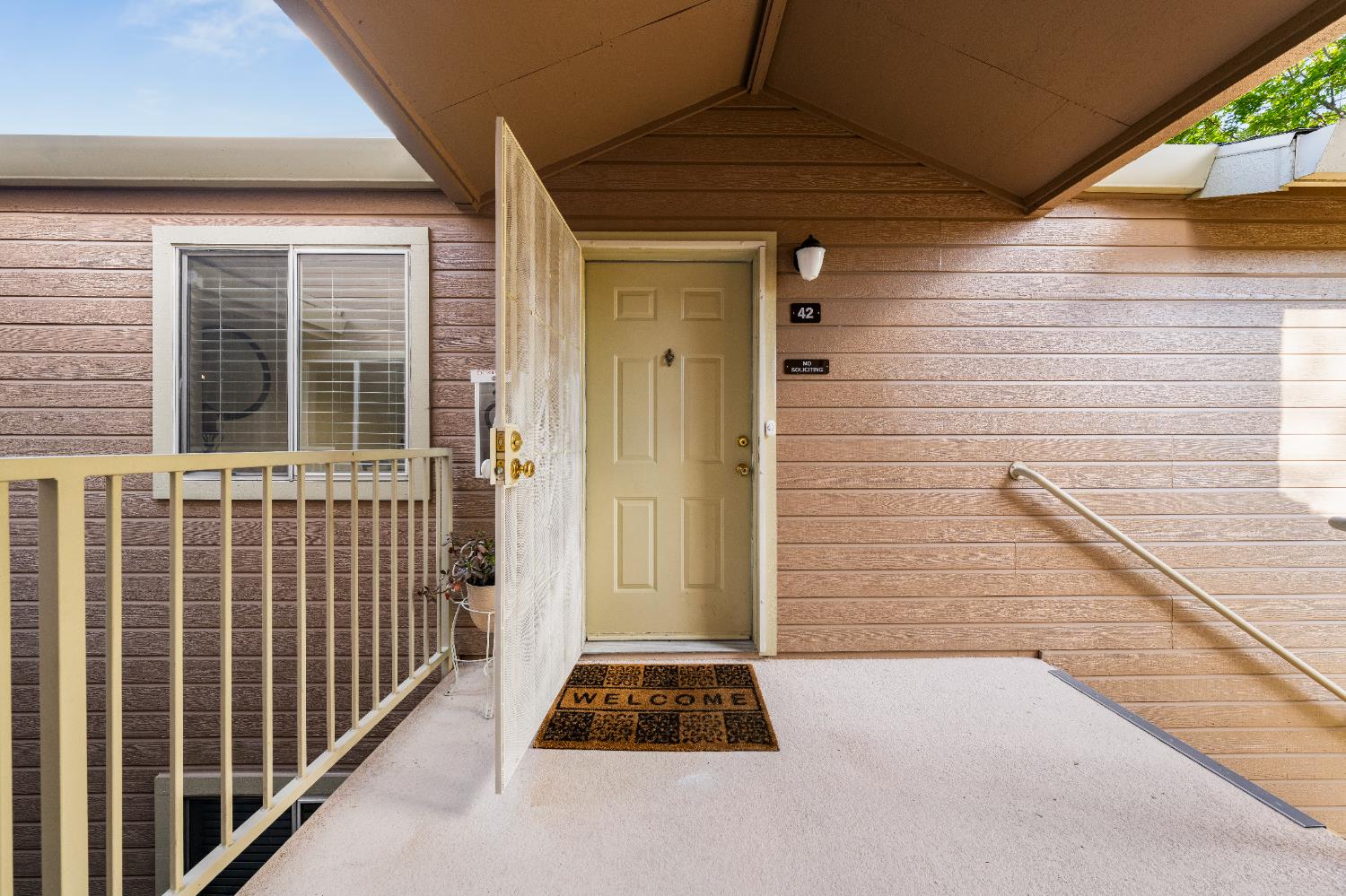 11150 Trinity River Drive, Unit 42 Rancho Cordova, CA 95670 - Photo 4 of 32 a front view of a house with a yard