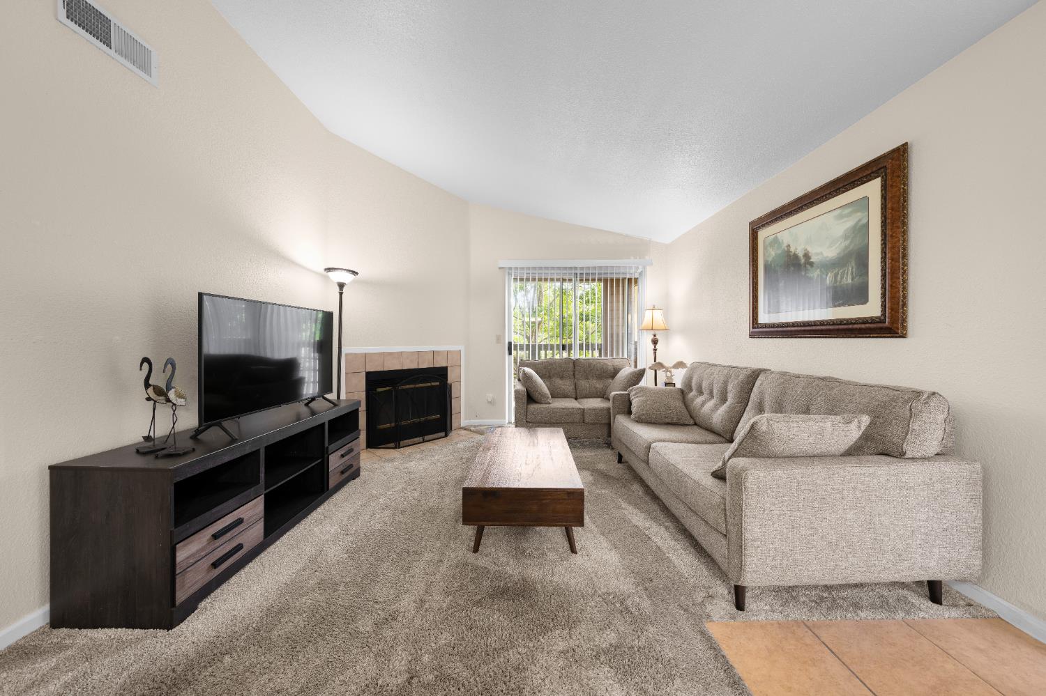 11150 Trinity River Drive, Unit 42 Rancho Cordova, CA 95670 - Photo 5 of 32 a living room with furniture and a flat screen tv