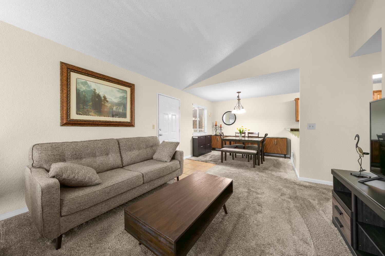 11150 Trinity River Drive, Unit 42 Rancho Cordova, CA 95670 - Photo 8 of 32 a living room with furniture and a table