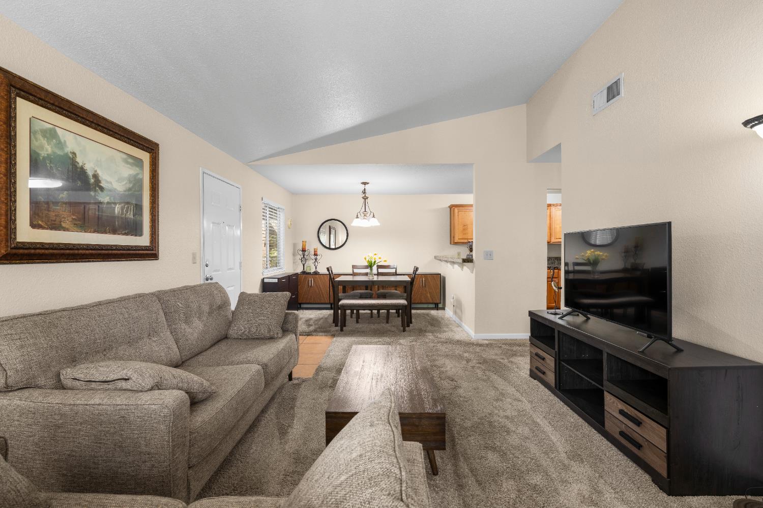 11150 Trinity River Drive, Unit 42 Rancho Cordova, CA 95670 - Photo 9 of 32 a living room with furniture and a flat screen tv