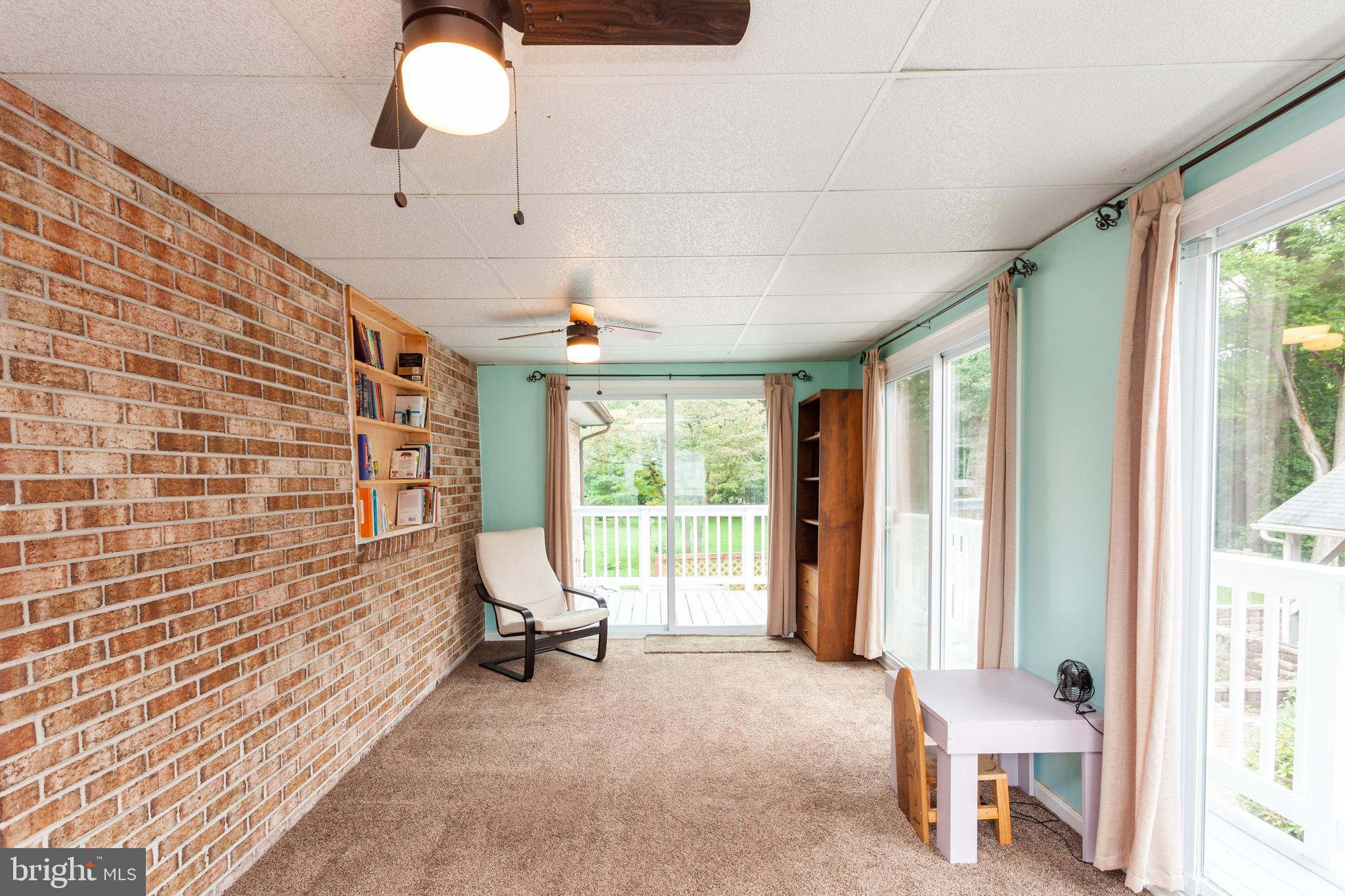 528 Conowingo Road Conowingo, MD 21918 - Photo 13 of 47 Rear sunroom with exposed brick