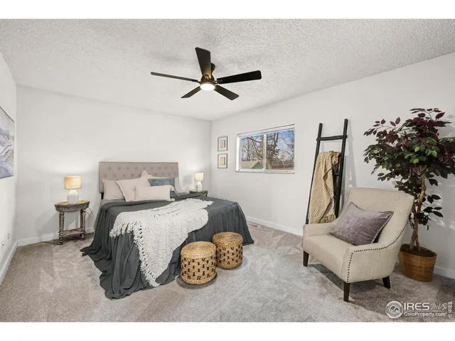 a spacious bedroom with a bed and a chandelier