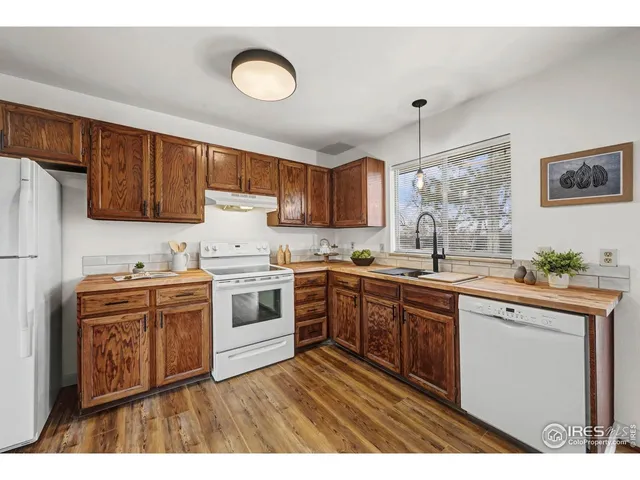 a kitchen with a stove a sink and a refrigerator