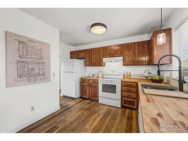a kitchen with a refrigerator stove and sink