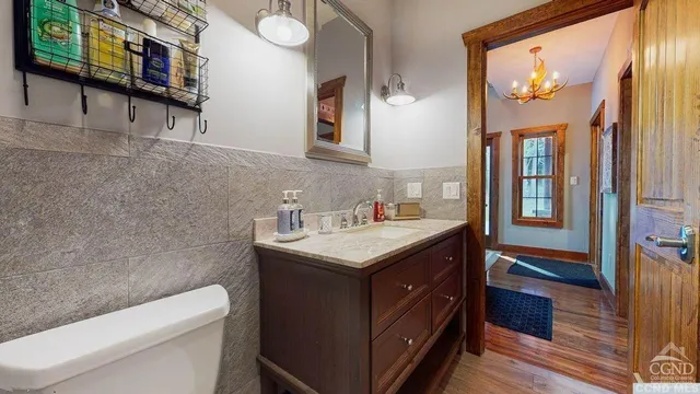 a bathroom with a sink a toilet and a mirror