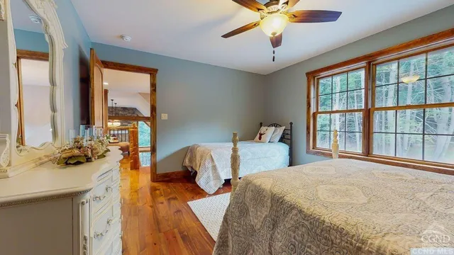 a bedroom with a bed and a large window