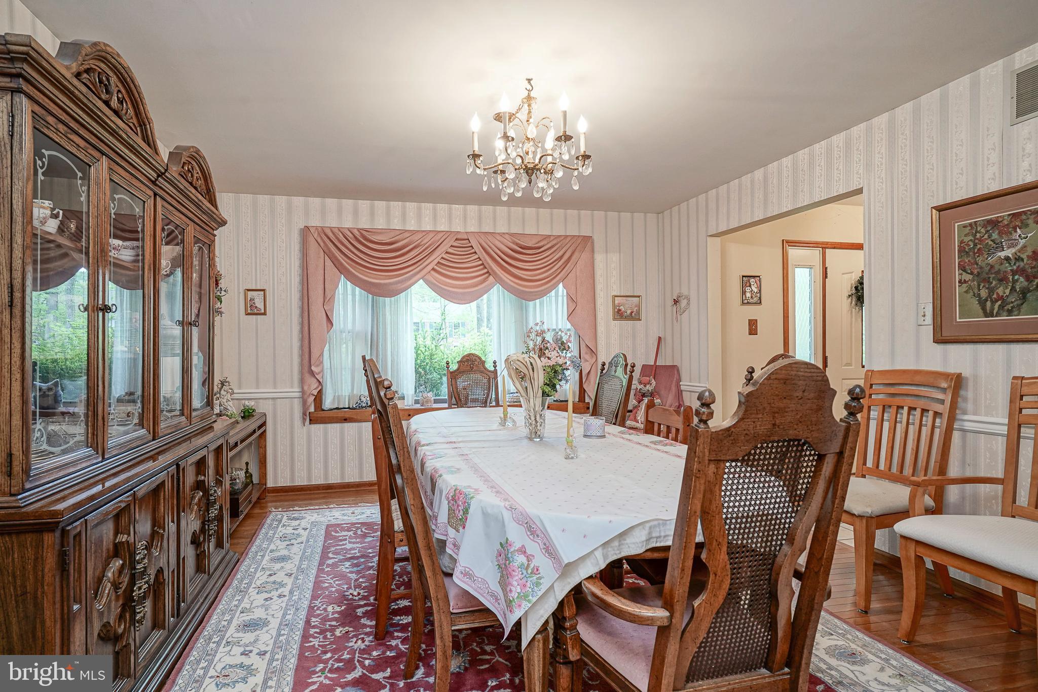 5 Meadowbrook Drive Shamong, NJ 08088 - Photo 6 of 39 a view of a dining room with furniture a chandelier and wooden floor