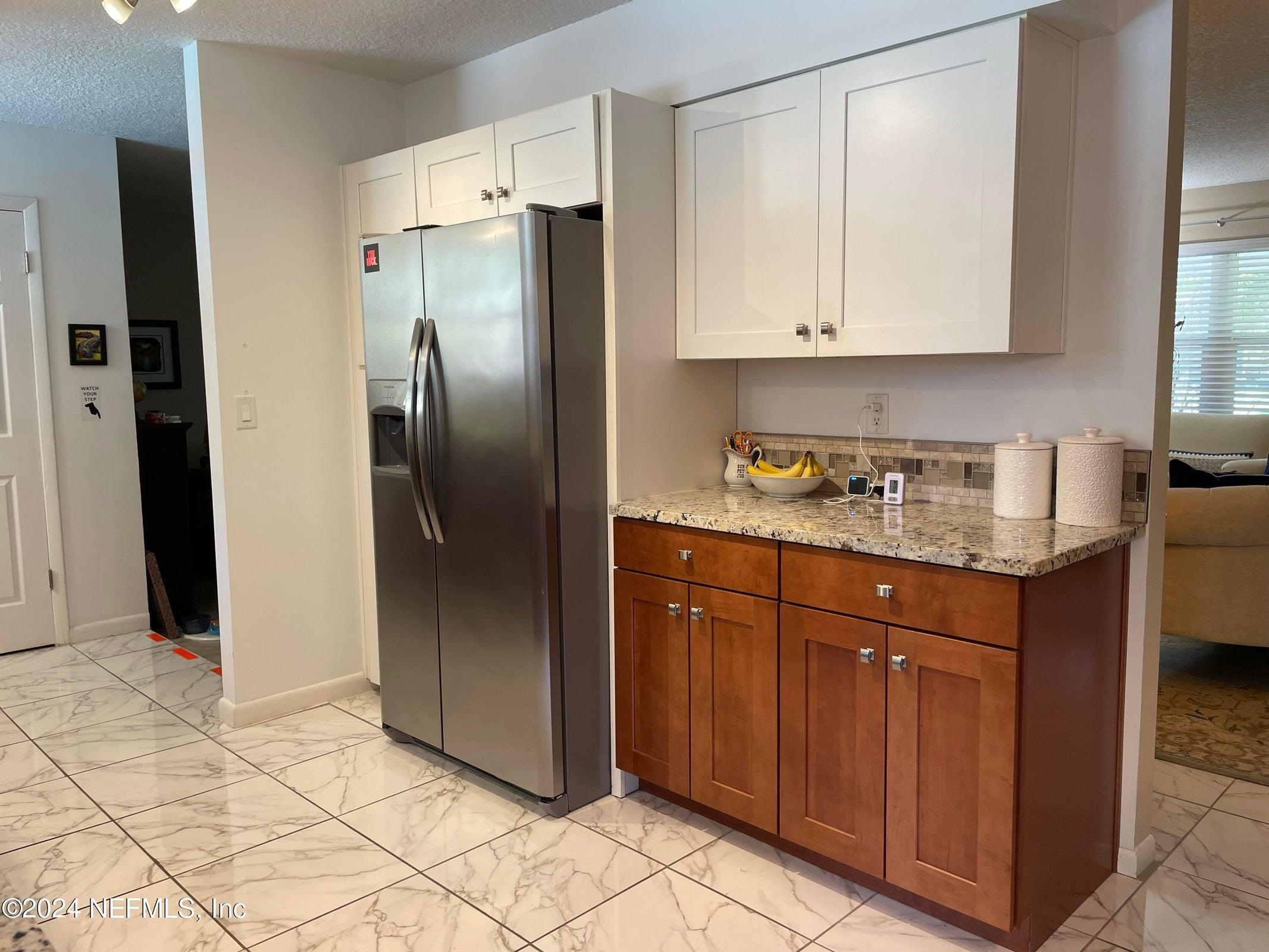 425 Gerona Road St. Augustine, FL 32086 - Photo 11 of 26 a kitchen with stainless steel appliances granite countertop a refrigerator and a sink