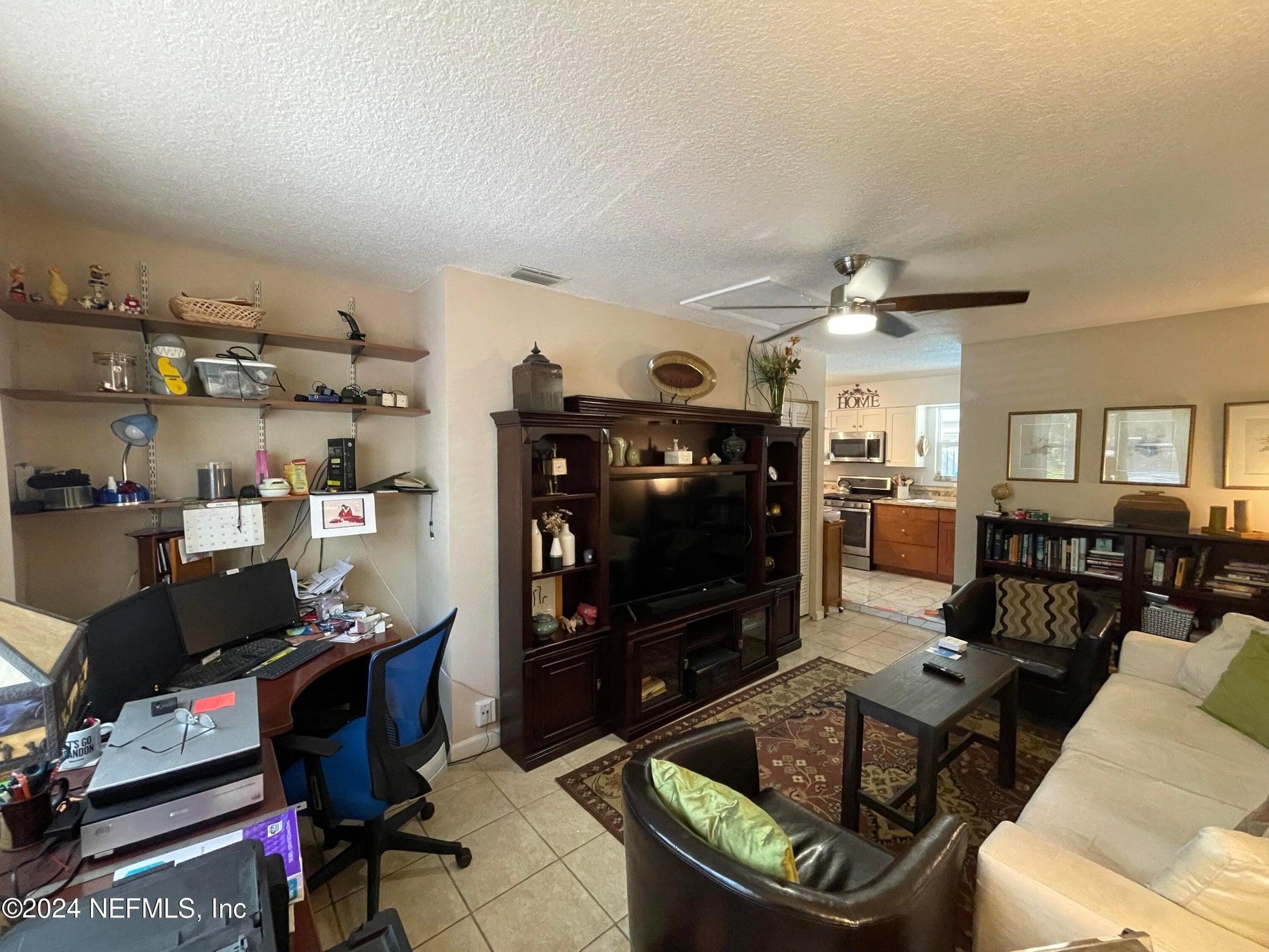 425 Gerona Road St. Augustine, FL 32086 - Photo 13 of 26 a living room with furniture and a flat screen tv