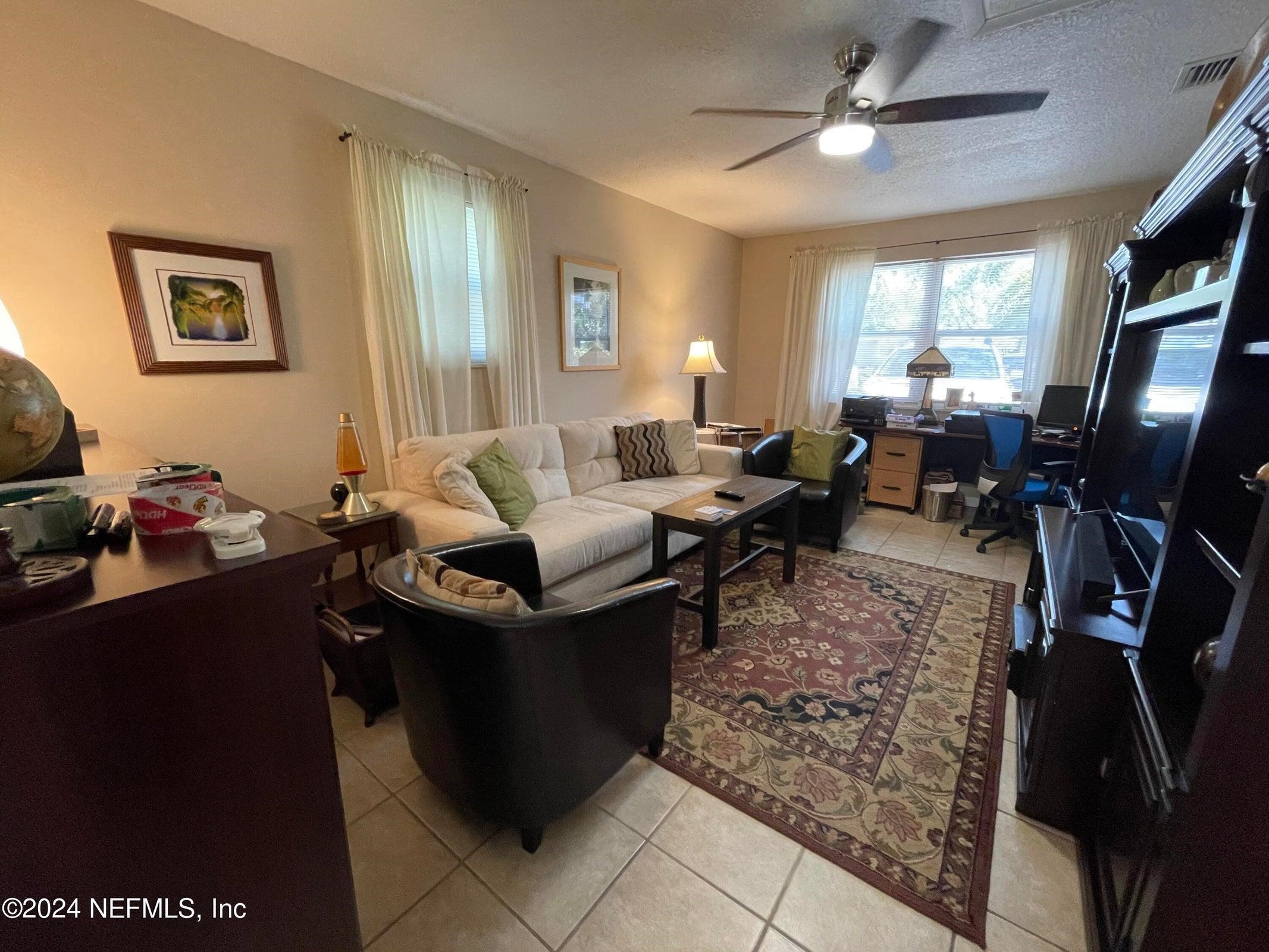 425 Gerona Road St. Augustine, FL 32086 - Photo 26 of 26 a living room with furniture a window and a flat screen tv