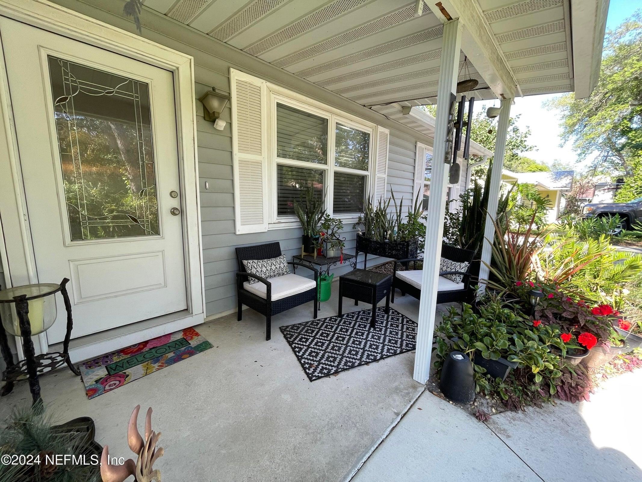 425 Gerona Road St. Augustine, FL 32086 - Photo 4 of 26 a outdoor living space with furniture and a potted plant