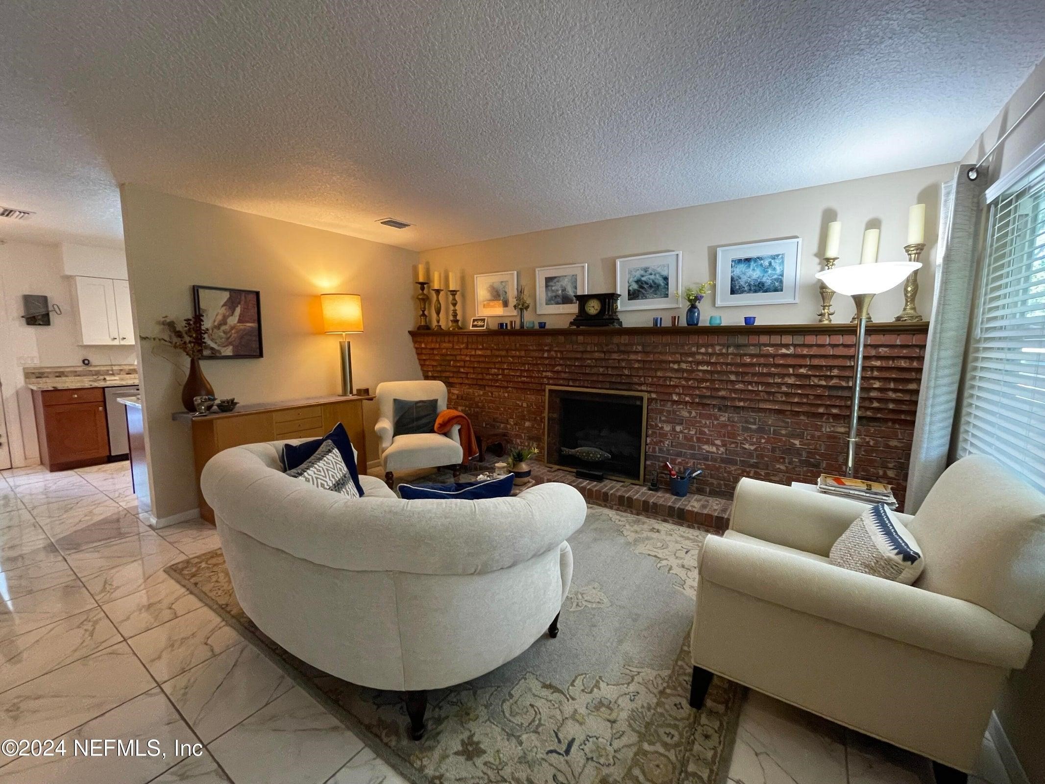 425 Gerona Road St. Augustine, FL 32086 - Photo 5 of 26 a living room with furniture and a fireplace