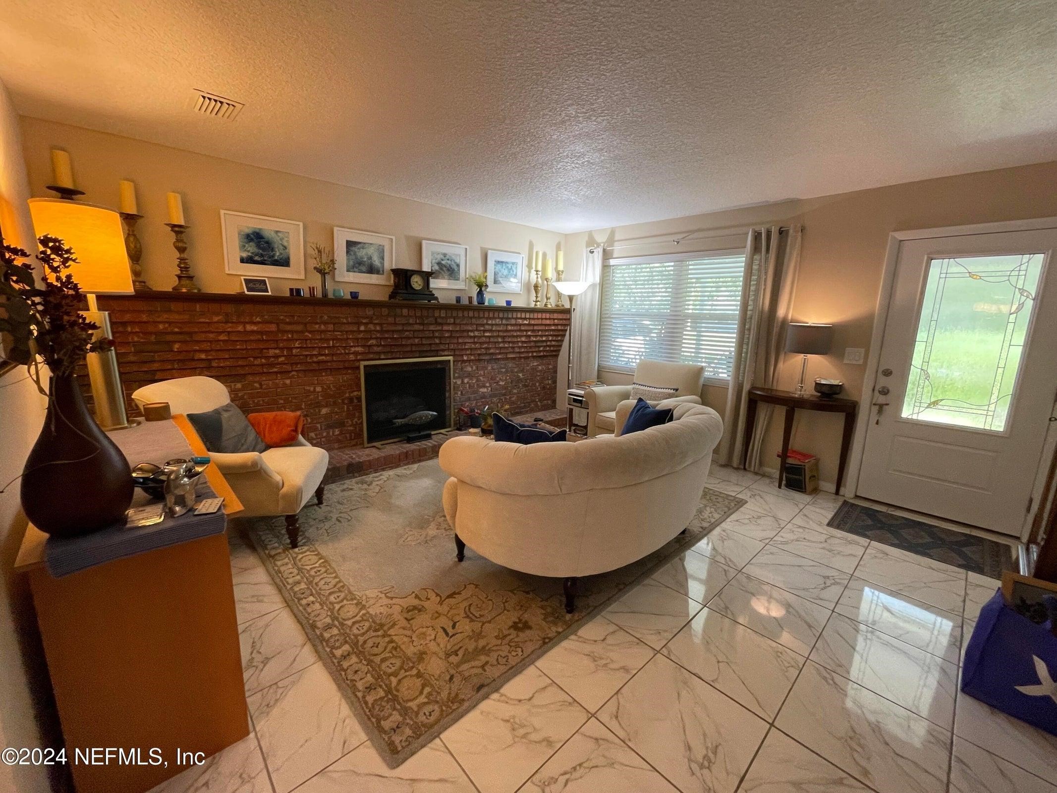 425 Gerona Road St. Augustine, FL 32086 - Photo 6 of 26 a living room with furniture and a fireplace