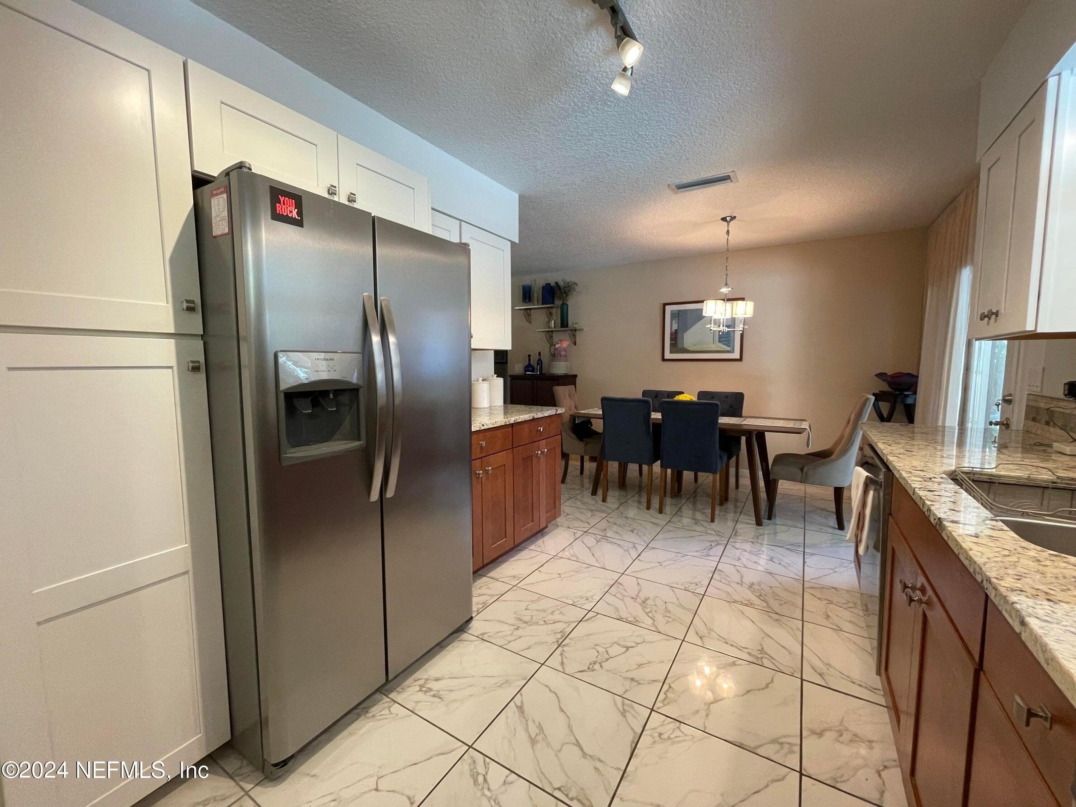 425 Gerona Road St. Augustine, FL 32086 - Photo 10 of 26 a kitchen with stainless steel appliances granite countertop a refrigerator and a stove