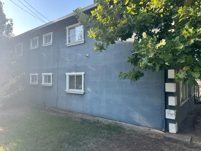 a front view of a house with plants