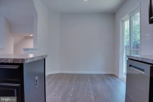 a view of a livingroom with kitchen and furniture