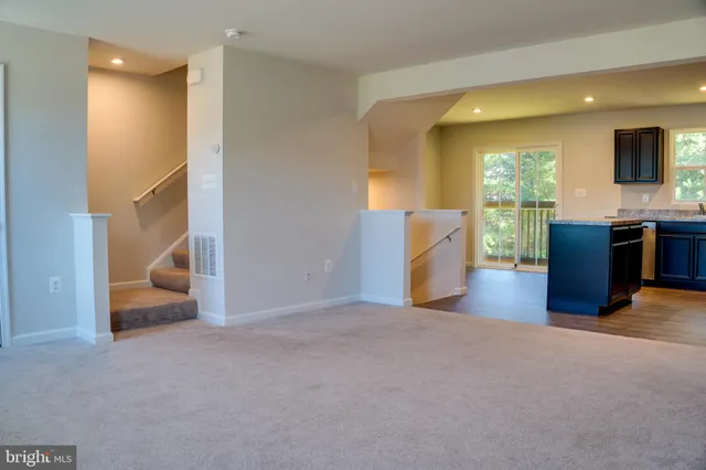 a view of kitchen with stainless steel appliances granite countertop cabinets and refrigerator