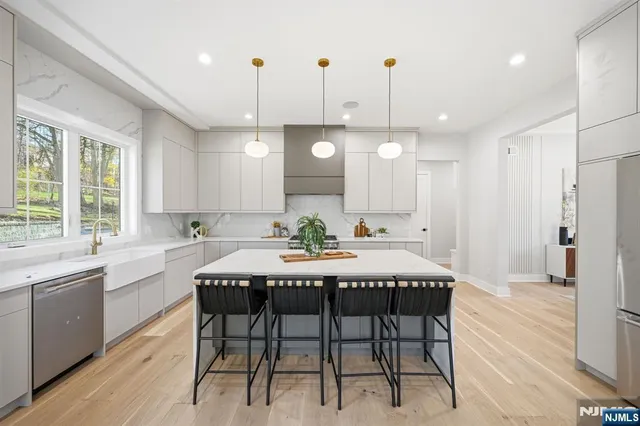 a large kitchen with a table and chairs