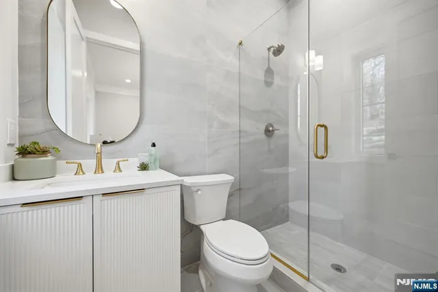 a view of a hallway with wooden floor and windows